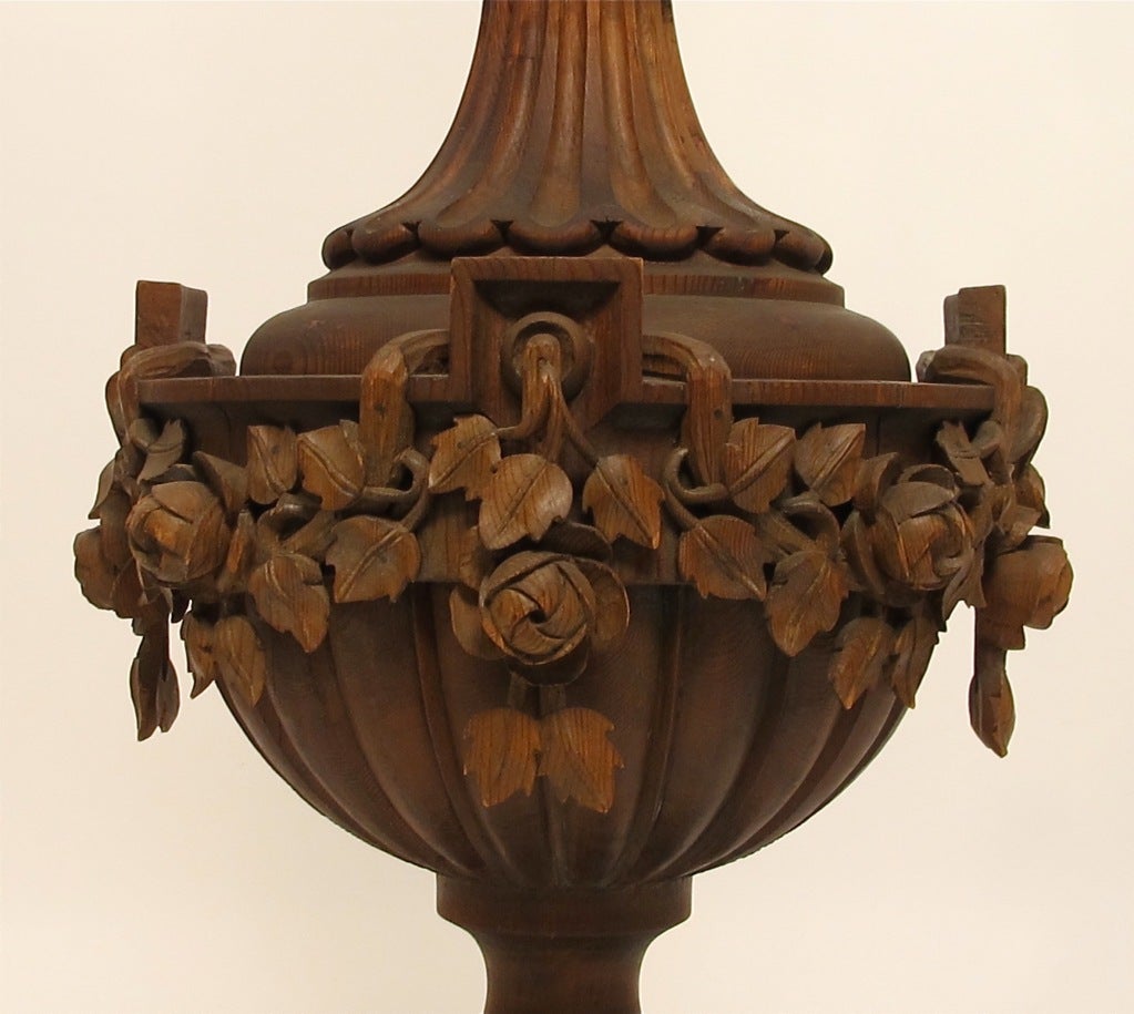 A large and impressive, beautifully carved wood lamp. Lovely form with carved leaves and flowers. Newly re-wired. Early to mid 20th century.
