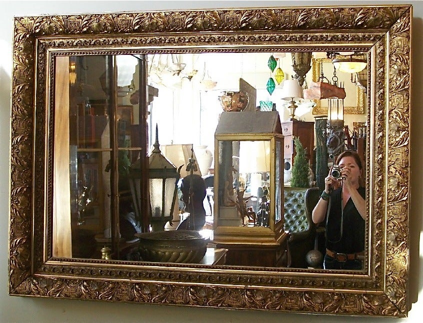 A large scale gilt and gesso wood frame mirror, beautiful detail and patina. Can hang horizontal or vertical.