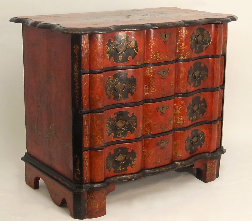 An exceptional serpentine shaped four-drawer commode. Beautiful deep red color with hand-painted chinoiserie decoration, and having its original hardware. Unusual smaller size, Belgium, 18th century.
