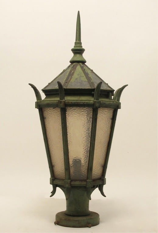 A large antique cast iron street light fixture with textured glass panels, made by General Electric. Having beautifully weathered old green paint (possibly original). American, late 19th-early 20th century.