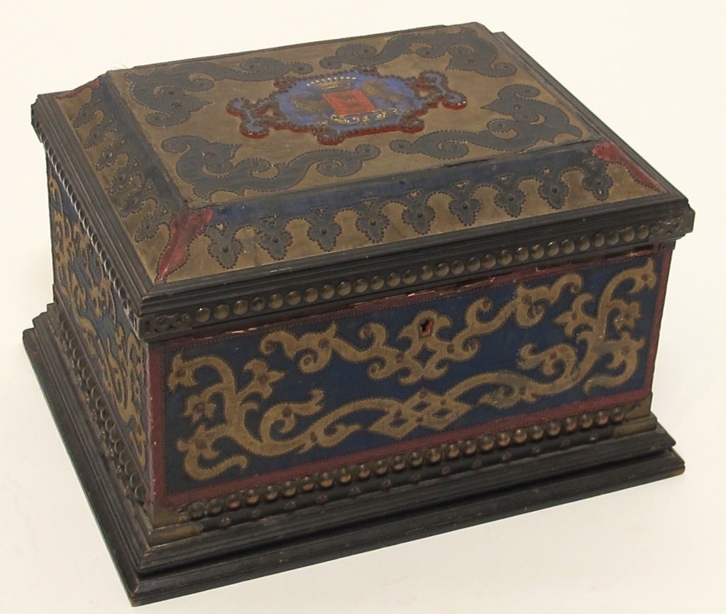 An interesting old document or keepsake box with hand-painted crest on top, covered with antique fabric and very unusual and fine nailhead design work.