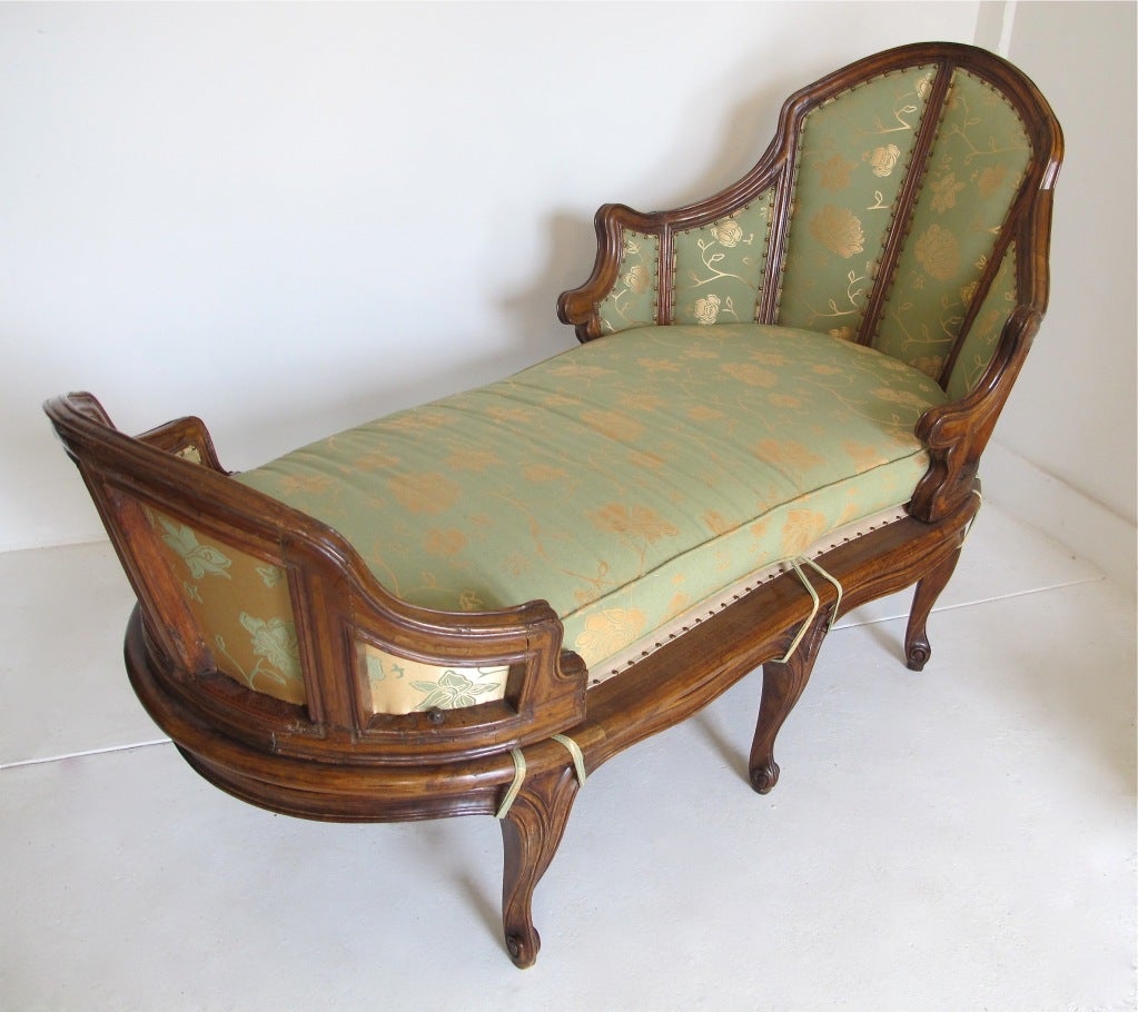 Unusual and elegant shape French chaise longue. Beautifully carved walnut with a rich warm patina.
The top part of this chaise is period 18th century, the base is newly made.