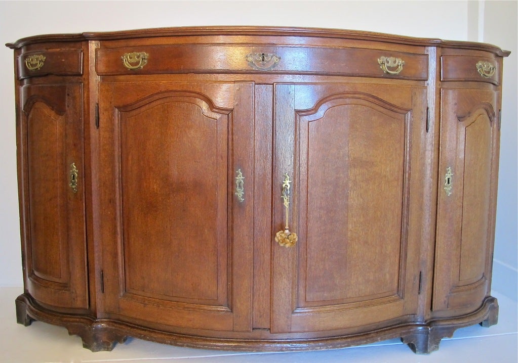 Baroque style and of the period, big and robust solid oak buffet. Great lines, shape and of architectural interest.