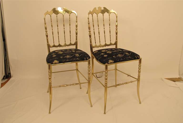 A classic pair of Italian brass chairs with newer upholstered seats.