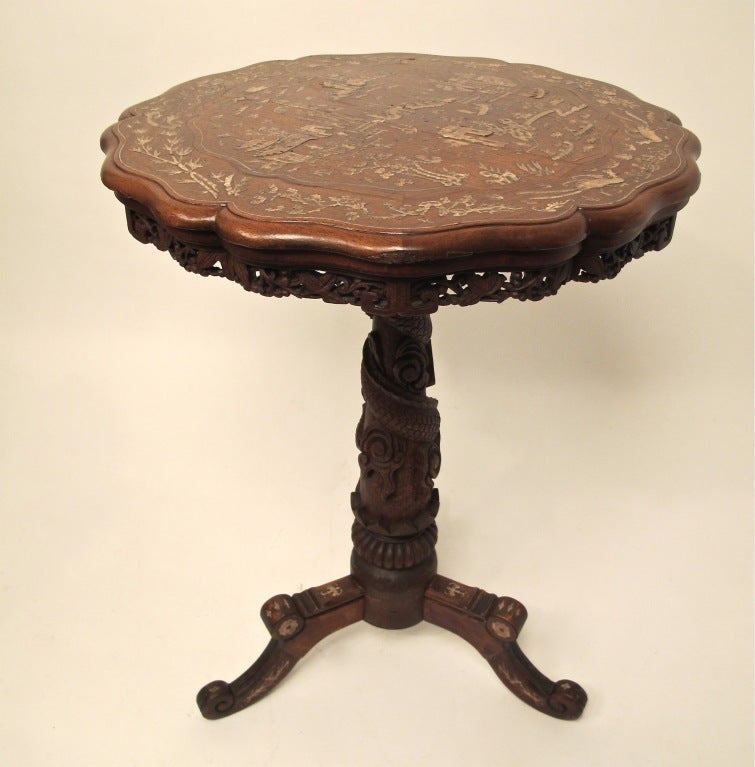 Carved teak wood side or occasional table with detailed mother of pearl inlay.