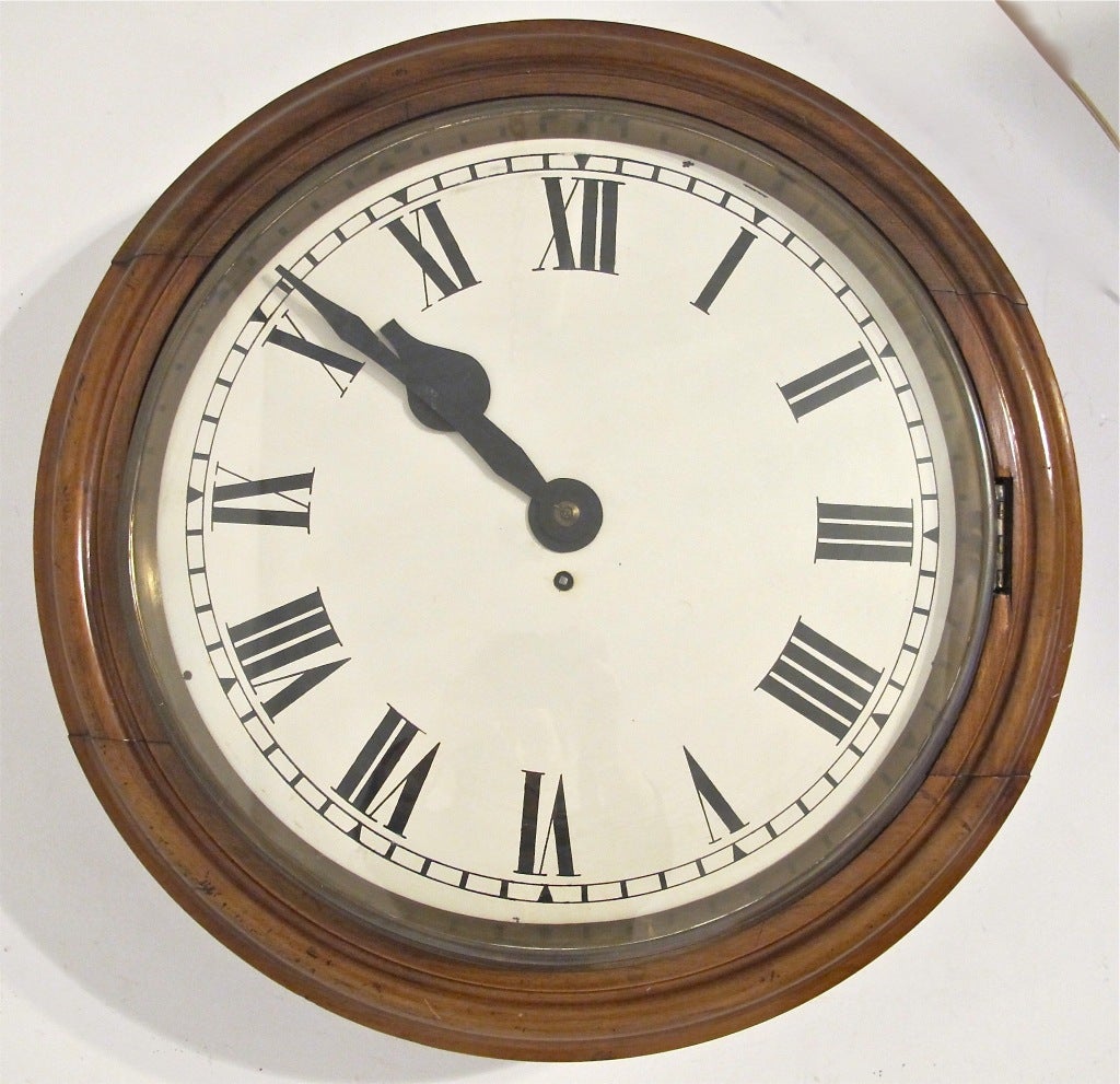 Large size clock, probably from a school or bank. Mahogany case with glass front.