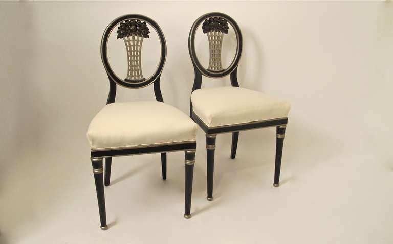 A pair of carved walnut and painted side or hall chairs. Sturdy and sound, recently re-painted. Probably French, possibly Austrian, crafted in the1920's - 1930's.  The chairs are currently covered in fresh muslin awaiting your upholstery.  The