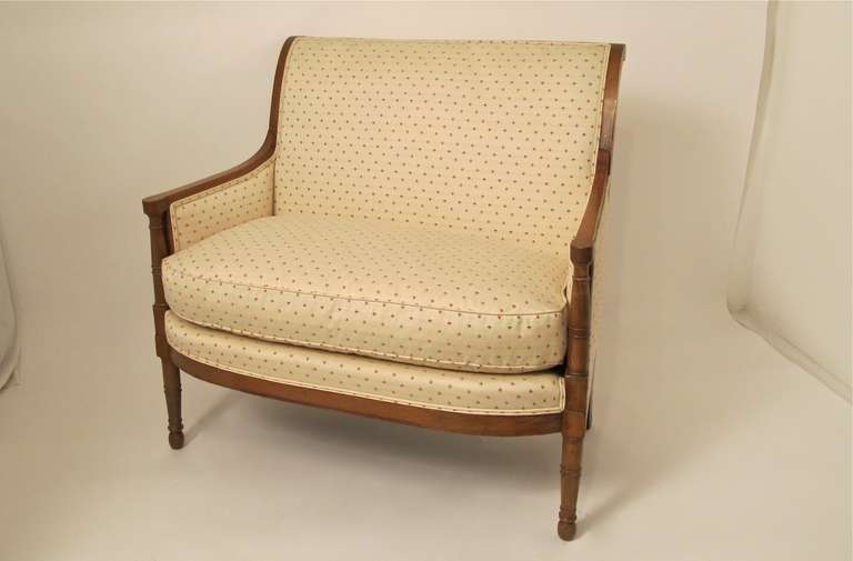 Fruitwood carved Directoire Sette, with turned arm supports, legs with rolled back top rail.  French, Circa 1780.
Reupholstered within the last five years, appears to have never been used very much.