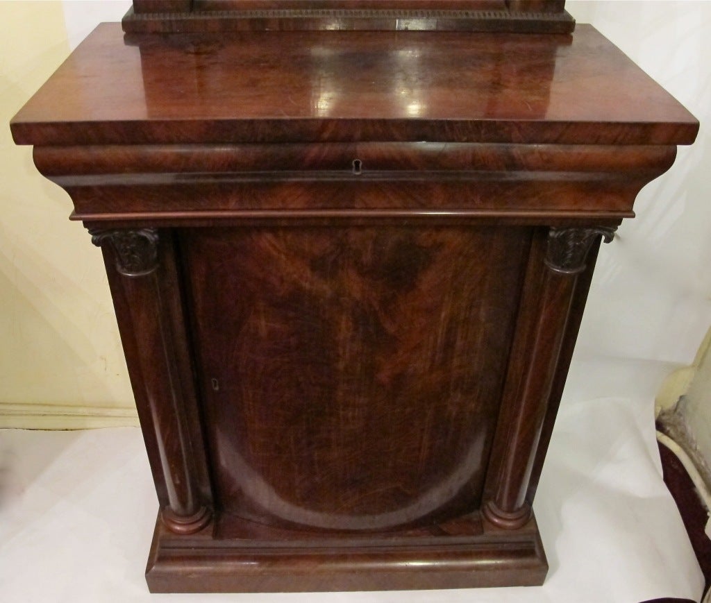 Neo-classical style mahogany console cabinet with original mirror. Bowed or rounded cabinet door, interior fitted with one shelf. Below measurements are for the cabinet, the mirror measures 60" high x 28" wide.