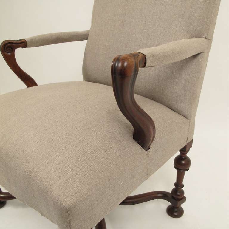A French 18th century walnut armchair. Chair is structurally sound, sturdy, and comfortable with generous seat. Ready for upholstery, we have this covered in a taupe linen for presentation.