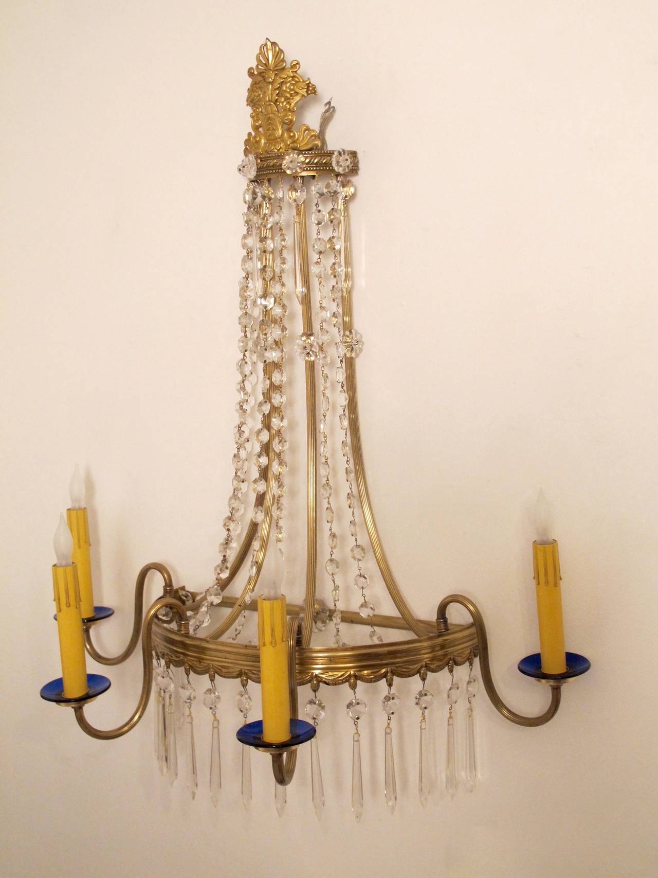 Fancy brass wall sconce with glass swags, crystal pendants and cobalt blue glass bobeches. Newly re-wired.