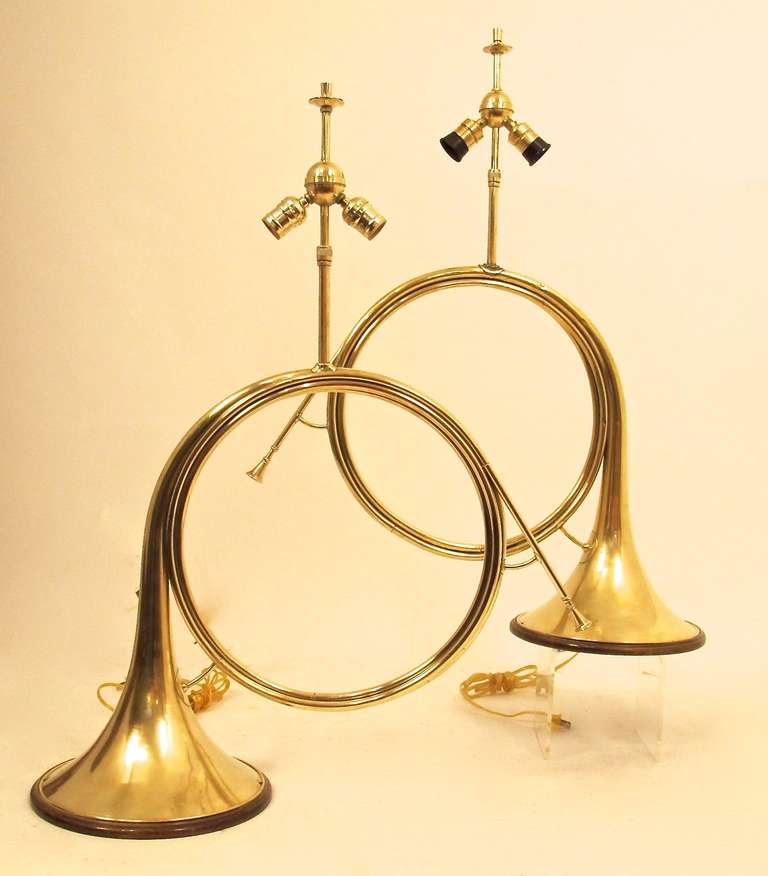 A pair of genuine French brass horns converted to table lamps. France, early 20th century.
