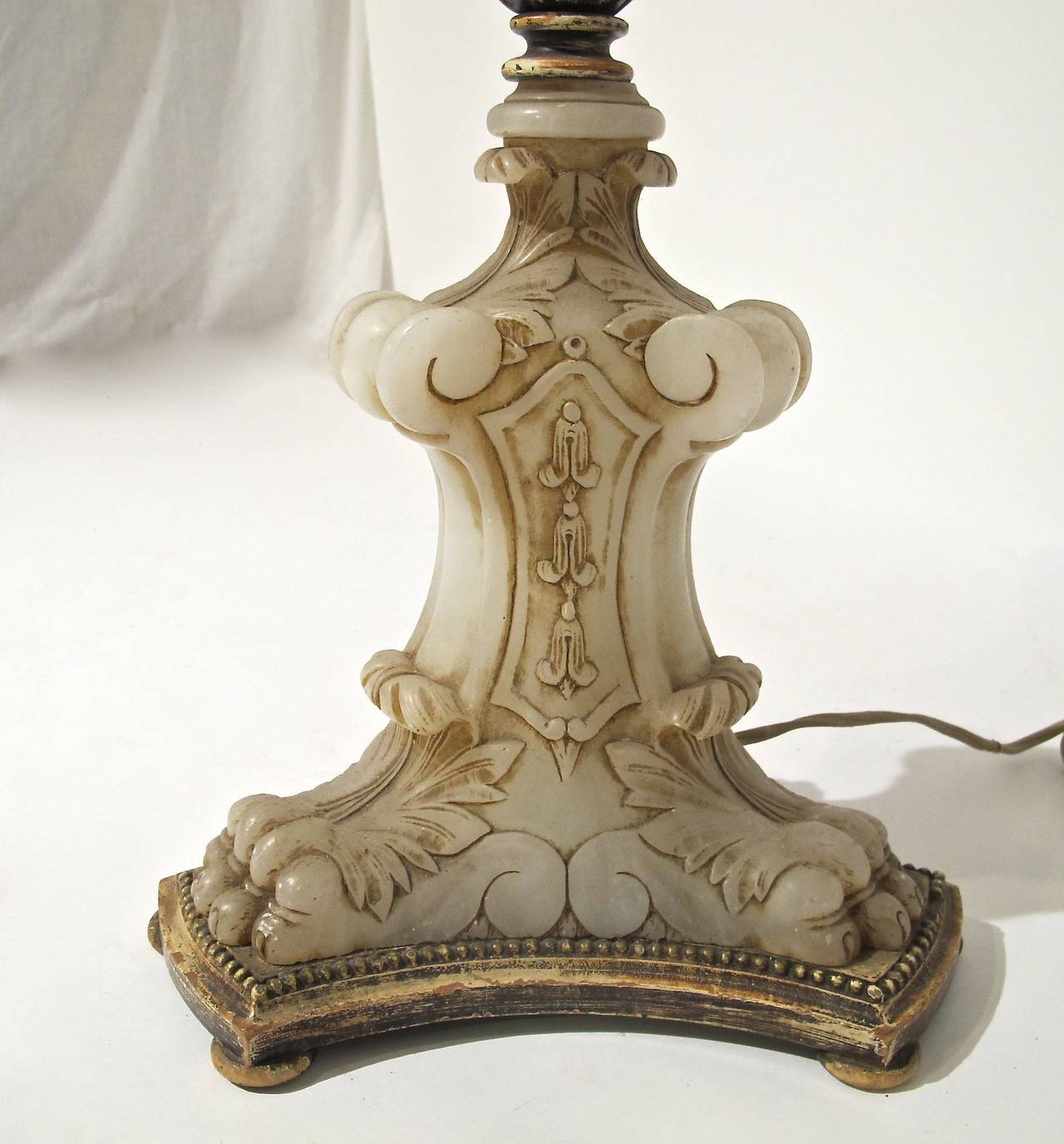 A very unusual and tall floor lamp with exceptional mica shade. Painted wrought iron with wonderful floral detail, great finial, and interesting hand carved alabaster base. Newly re-wired.