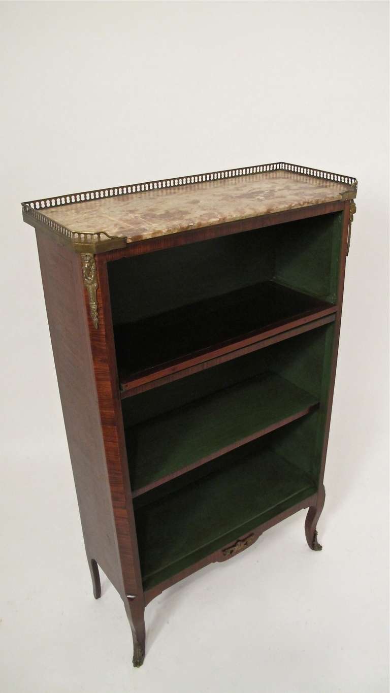 Small mahogany book shelf with rouge marble top, brass gallery and brass mounts. Has newly painted interior.