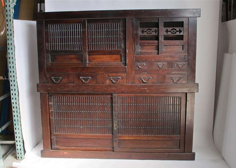Large two piece cabinet in original condition, made of Keyaki (zelkova) and Hinki (cypress) wood with hand forged iron hardware.