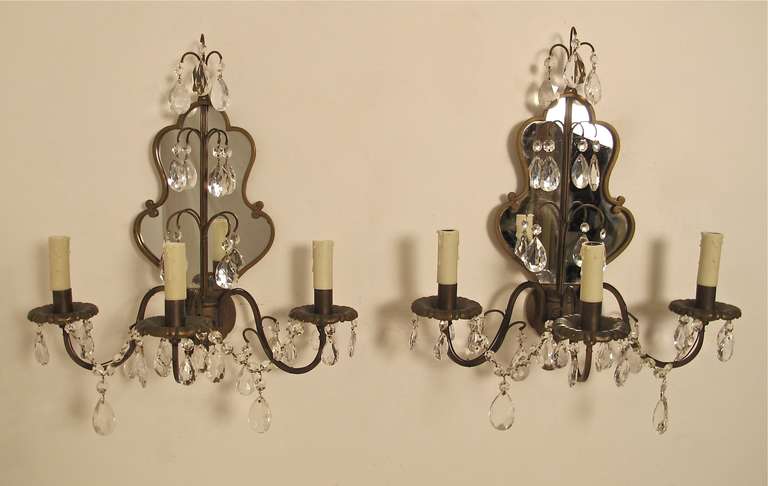 A pair of sconces with mirror backs and crystal and glass pendants. Newly re-wired, and new wax candle sleeves.