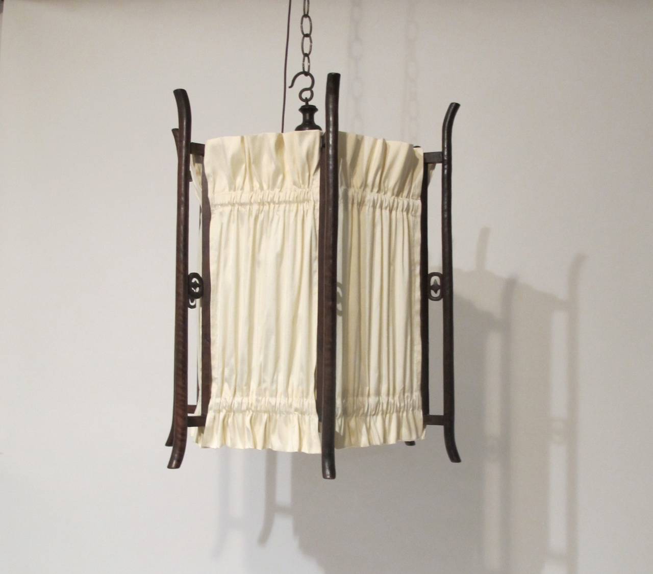 Hexagonal Hanging Lantern with Ivory Shantung Silk Panels stretched between finely craved and ribbed support arms.  Chinese, Qing Dynasty, Circa 1880.  Recently electrified.