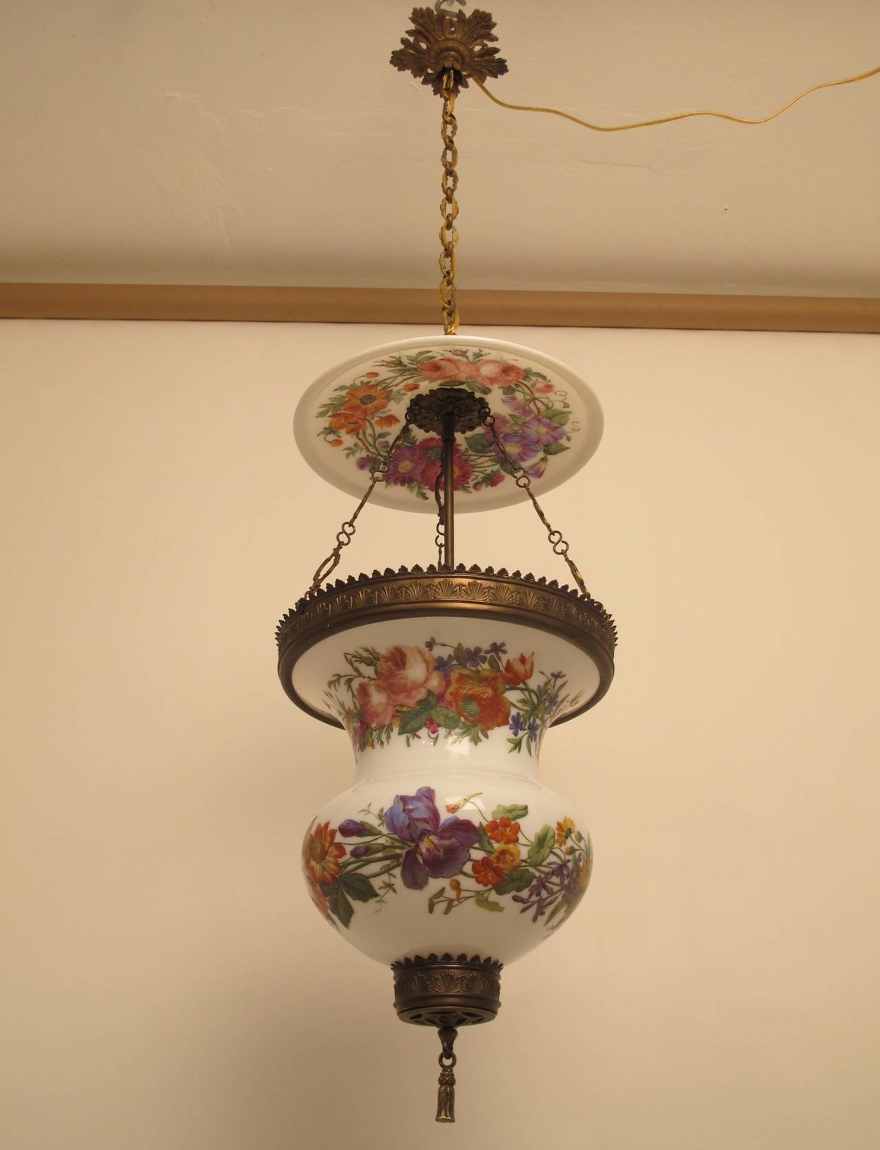 A rare and unusual large scale hurricane candle light lamp with exquisitely hand painted floral decoration. Wonderful original condition and with original canopy. Newly wired for electricity, holding a single standard size light bulb. American, mid