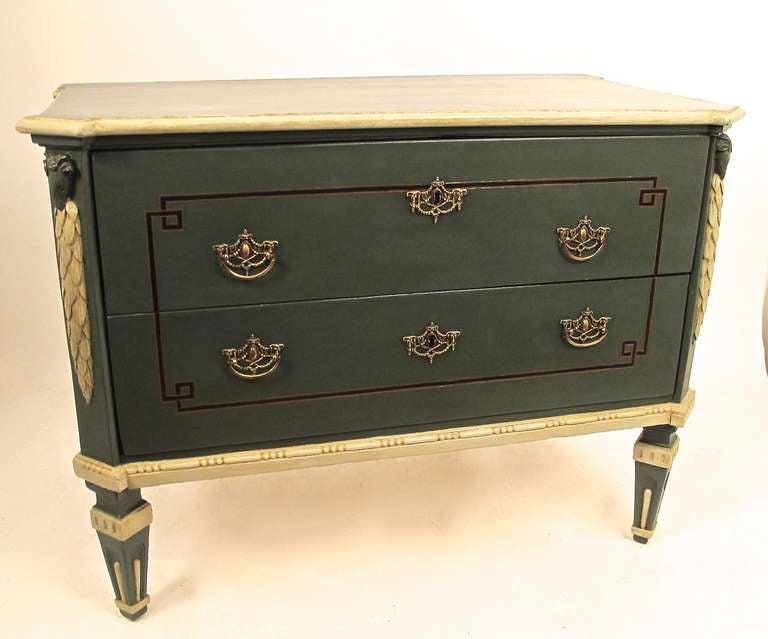 Scandinavian style painted two-drawer commode. The chest has been recently painted but retains the original ebonized inlay decoration, carved ram's head and garland detail. Possibly Danish, circa 1890.