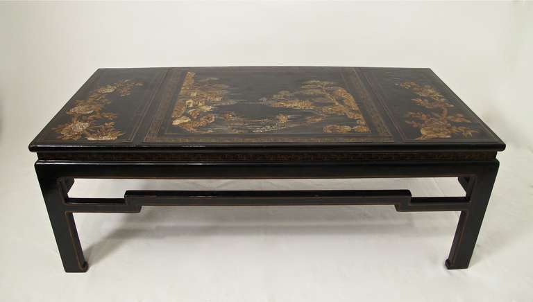 Black lacquer coffee table with three inset panels, center panel with gilt highlighted village scene. Chinese 19th century panels inset to a custom made base in the first half of the 20th century.