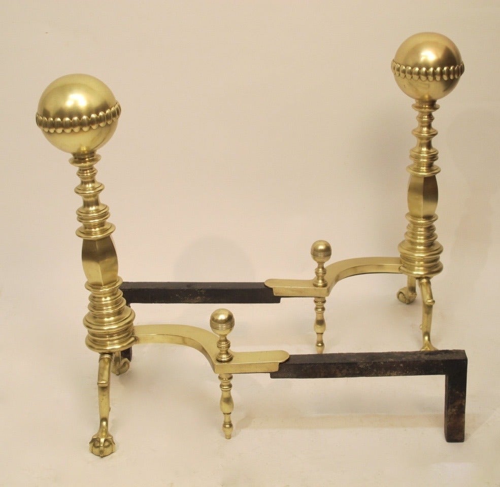 A large pair of brass and cast iron andirons. American, late 19th to early 20th century.