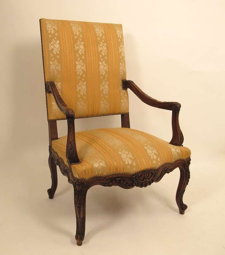 Carved Walnut Style Regence Fauteuil with cabriole legs ending in scroll feet.  Belgium, Circa 1900.