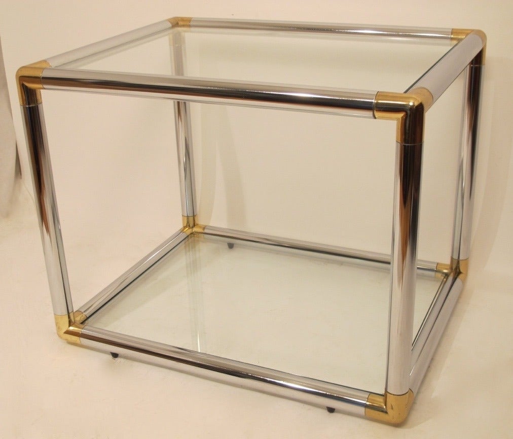 A pair of mid-20th century tubular chrome, brass and glass side or end tables. The tables are ever so slightly different in size, Italian, circa 1970.