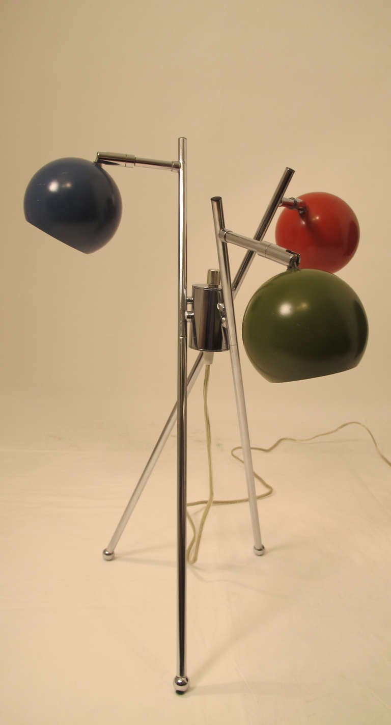 Pair of Three Light Modern Lamps with painted globes supported on chrome tripod legs ending in ball feet.  The globes can be swiveled and angled.  Possibly Italian, Circa 1970.