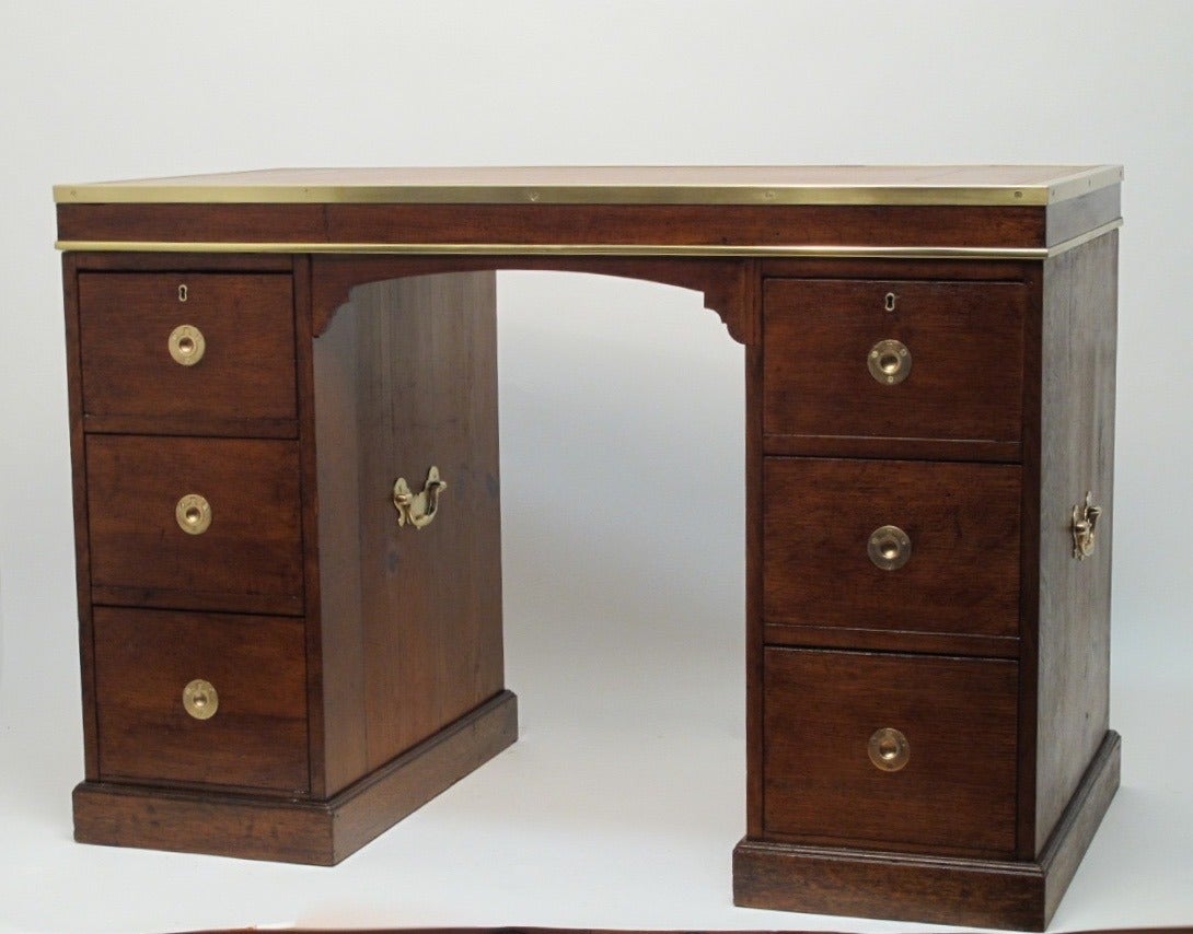 Oak Campaign desk with tooled leather top, brass hardware and brass trim.