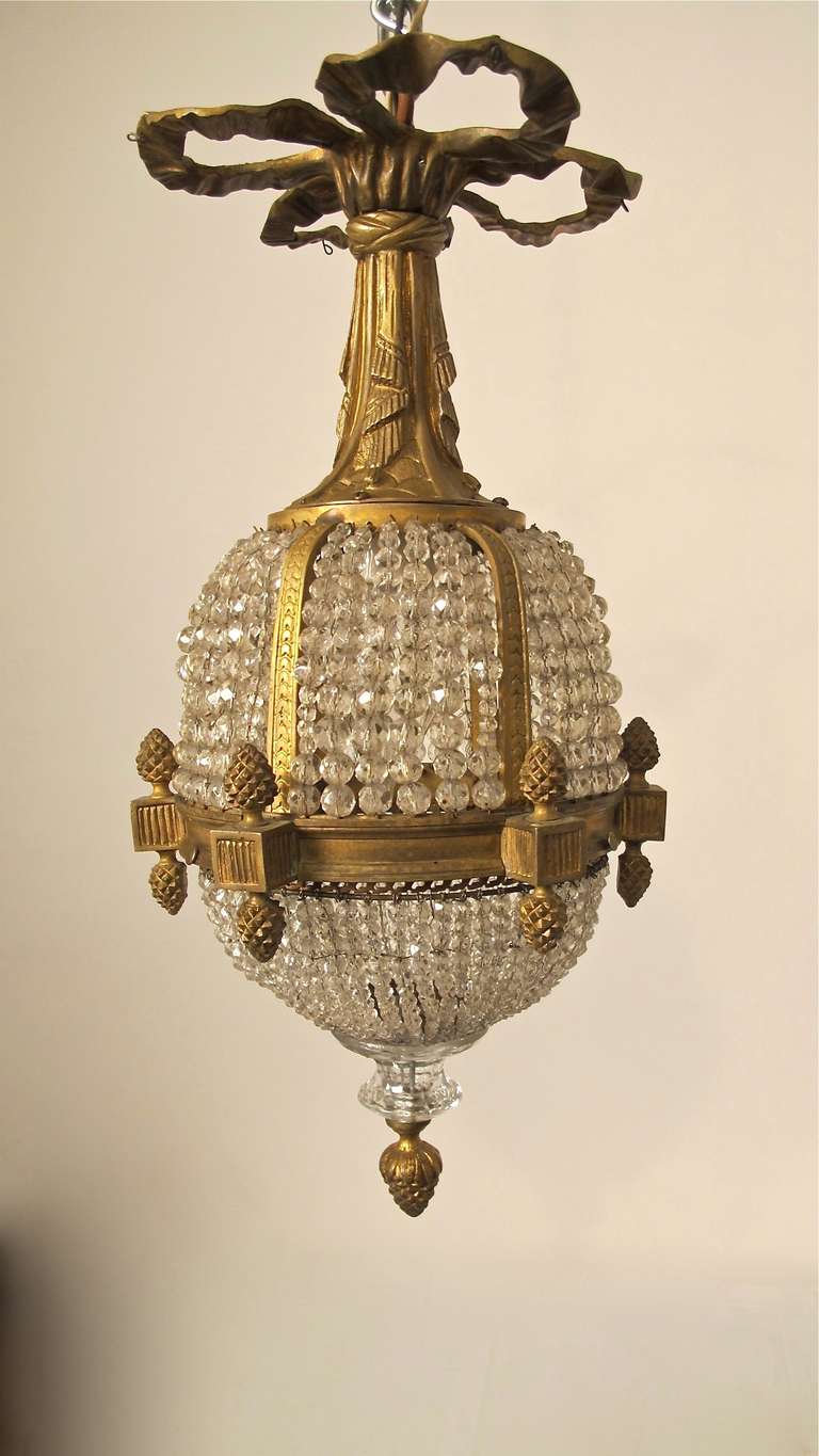 Small brass and beaded cut glass flush mount light fixture. Recently rewired, holds one standard size light bulb.