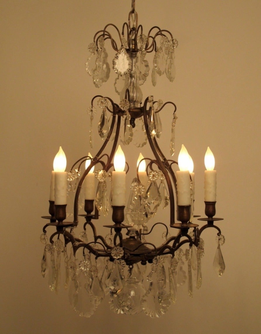 Pear shaped eight light bronze chandelier with fine cut crystal drops and center spire. Newly re-wired. Includes 13 inches of chain and canopy. France, late 19th to early 20th century.