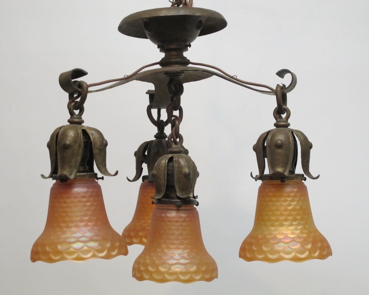 A hand hammered brass light fixture with carnival glass shades. Newly re-wired.
American, circa 1930.