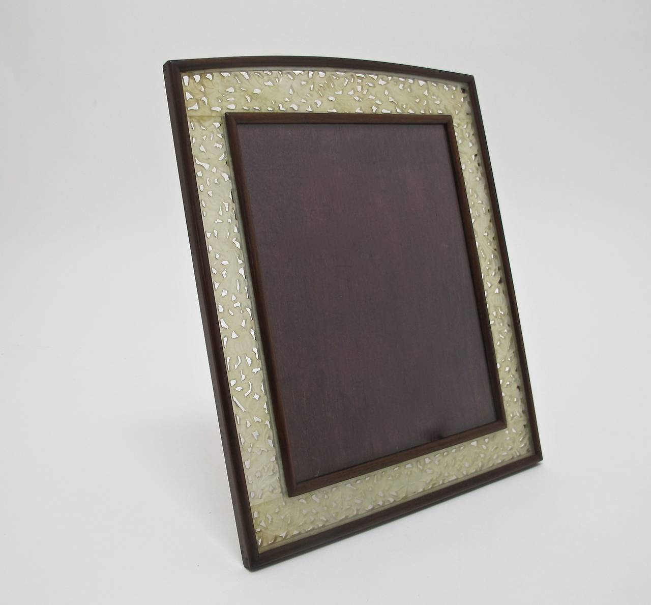 A lovely large antique picture or photo frame with reticulated carved white jade in a scrolling floral pattern. Frame measures 13 3/8
