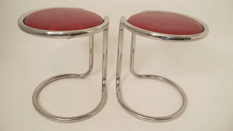 Unusual chrome plated stools with original red vinyl upholstery.