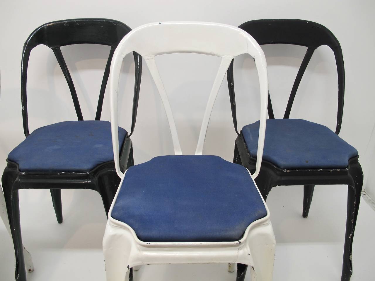 Art Nouveau style painted metal cafe chairs in original condition. One black, one dark green and two white chairs. Sold separately at $135.00 each.
