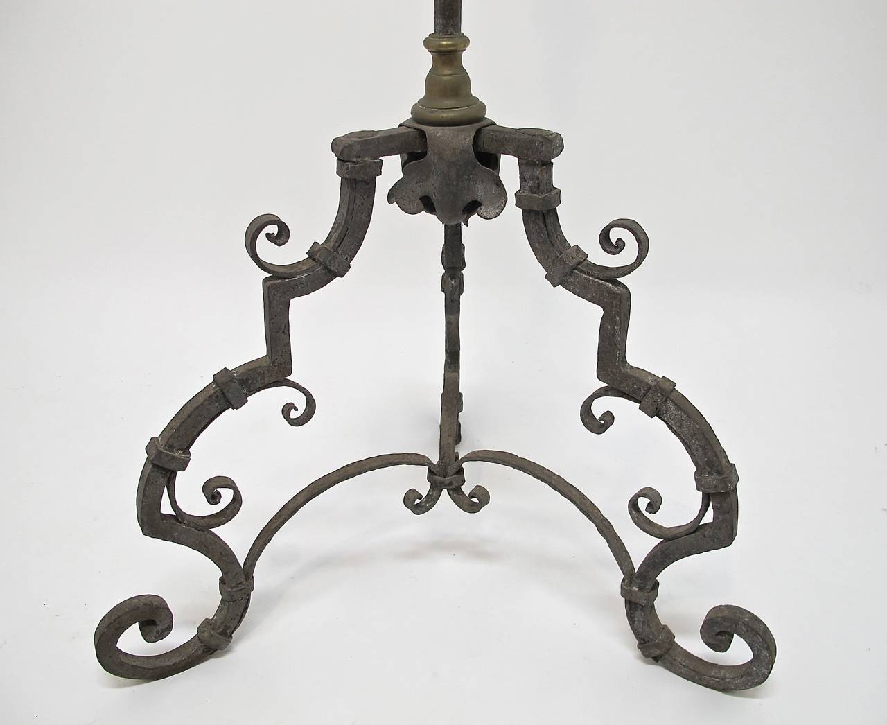 An impressive large and heavy three legged wrought iron candle stand with bronze hardware detail. Italy, 18th century.
