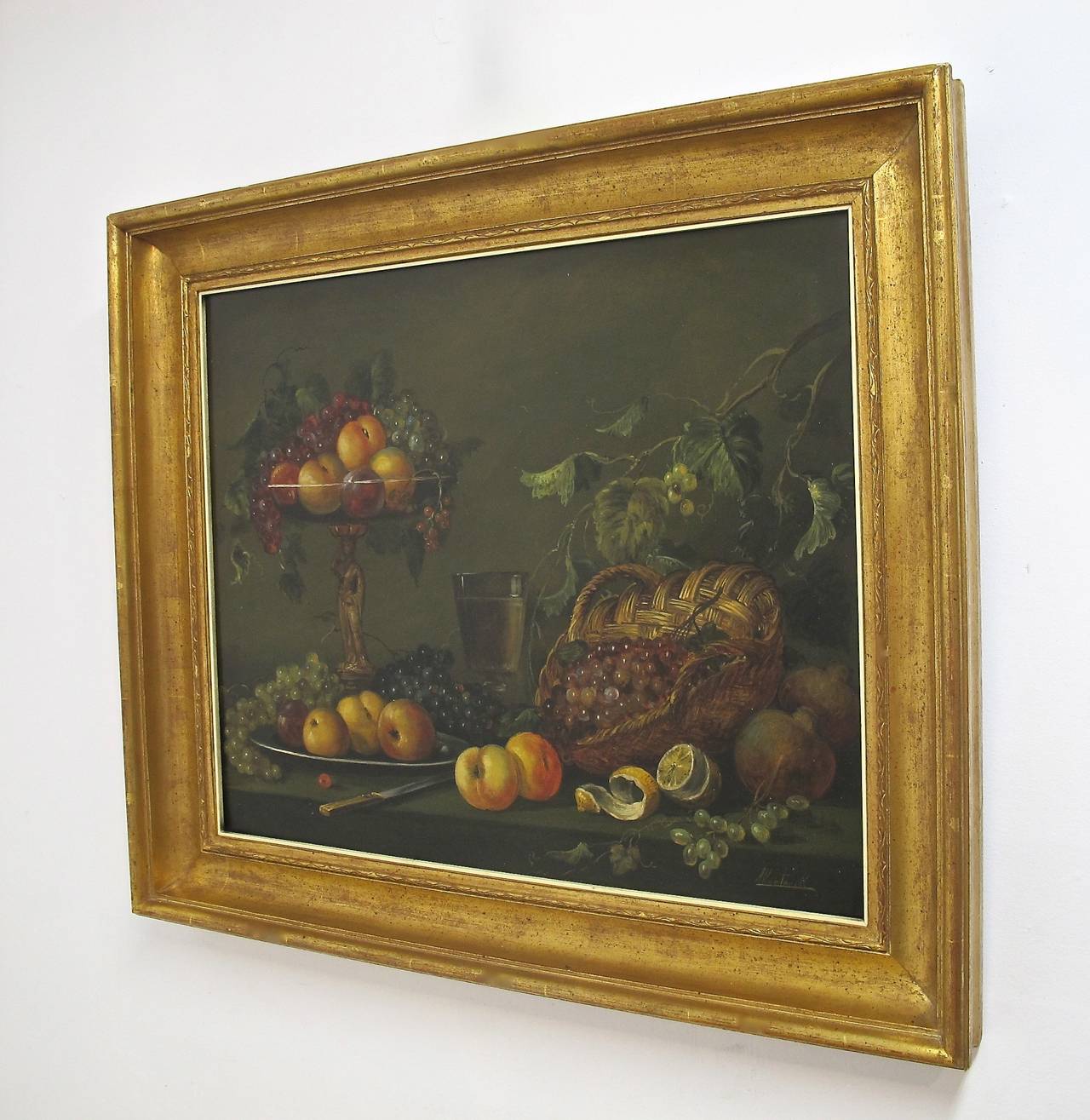 Wonderfully mellow and vibrant still life of fruit on platter and over flowing from woven basket and on a glass compote.  Executed in the style of 18th. and 19th. century still life.  European, signed Montorill.  20th. Century