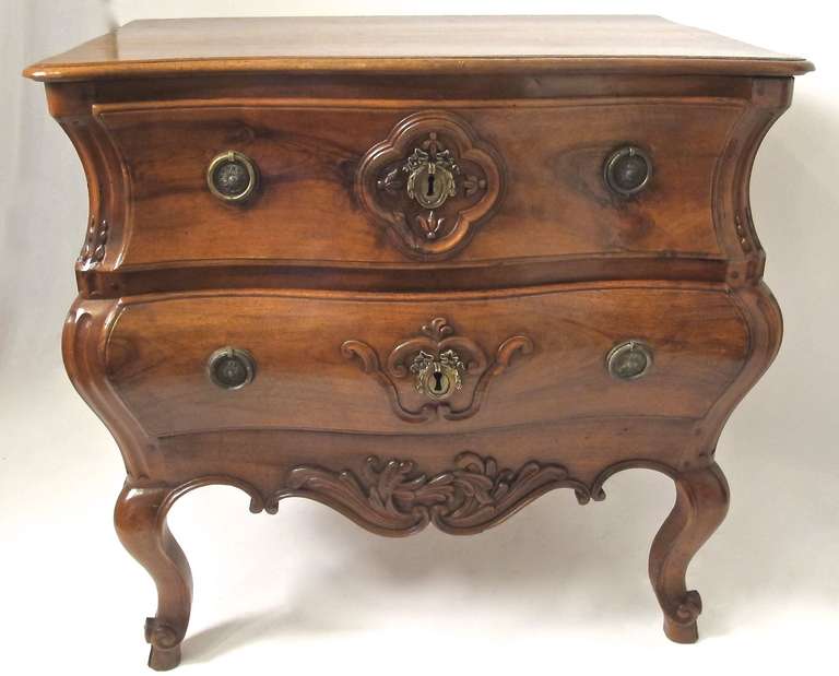 Exceptional Louis XV Bombay Walnut Two Drawer Commode with carve cartouche surrounding the esutcheons on cabriole legs ending in scroll and hoof feet.  French, Circa 1760.