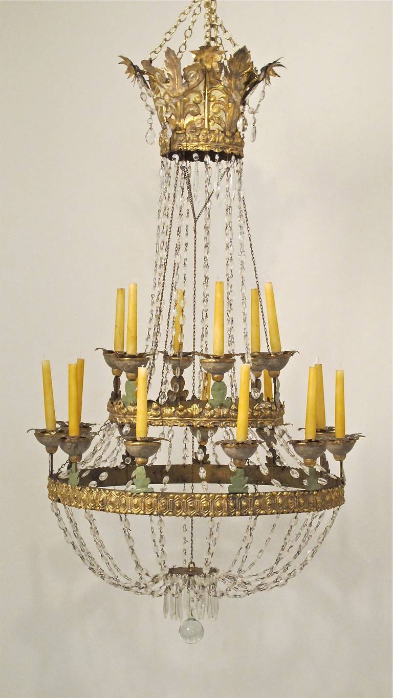 Painted iron with brass repousse work, cut out painted tin drip plates and cut glass swags and prisms. Restored and reconditioned. Italy, late 17th to early 18th century. not electricfied.