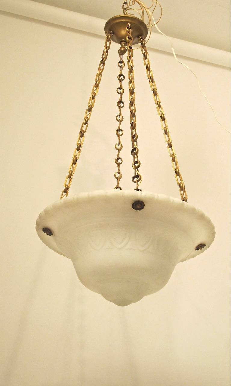 An exceptional and beautifully cast glass bowl, pendent light fixture with solid brass hardware (probably Chicago Glass Co.) Reconditioned and newly rewired. American, early 20th century.