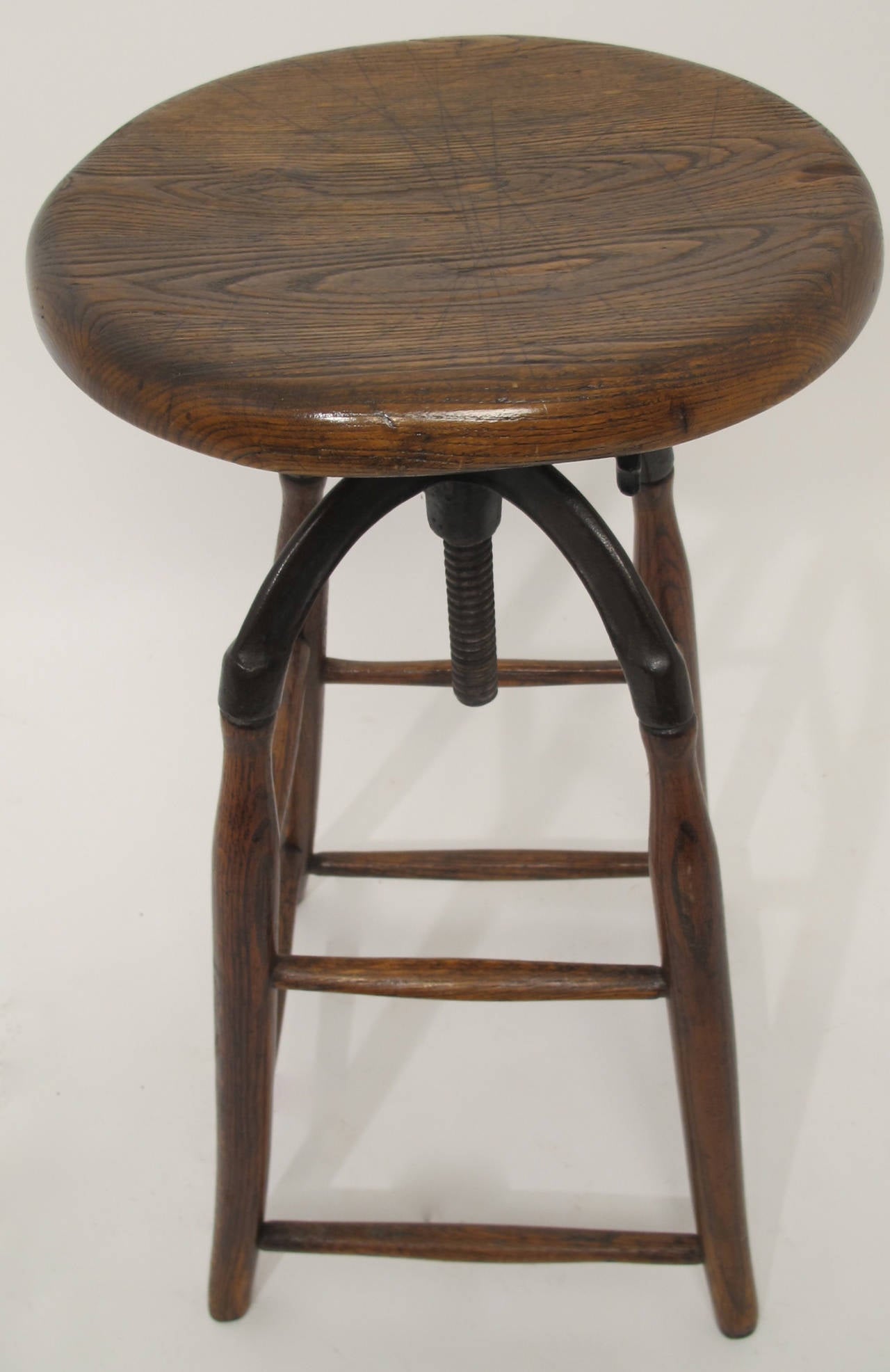 Great American Oak and Black Iron Industrial Stool with adjustable seat height and swivel stop.  Both are functioning.  All original.  Seat Height is adjustable up to 34