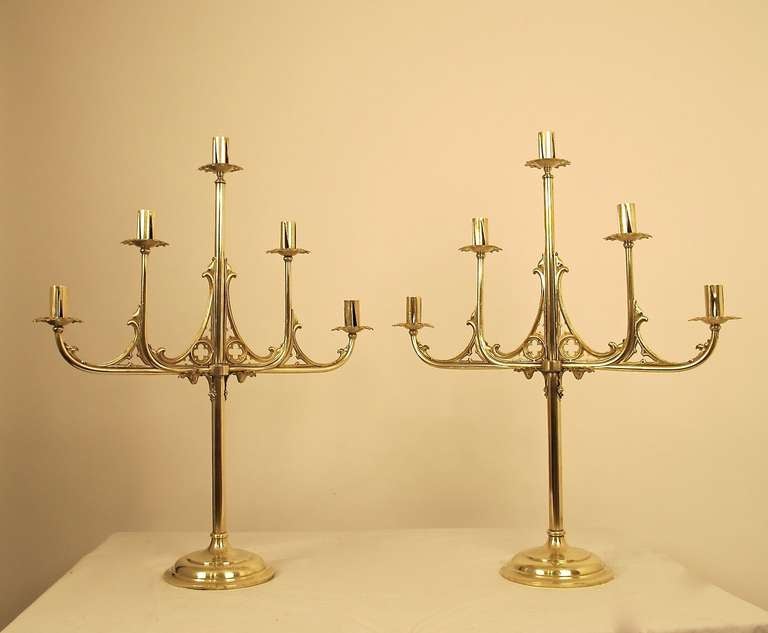 A dramatic pair of large solid brass candleholders, circa 1850. Brass has a satin lacquer finish. European, mid 19th century.