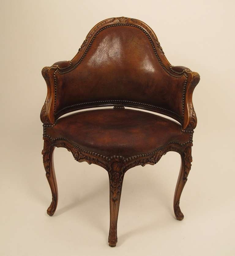 High quality, handmade, solid walnut chair with beautifully aged and worn leather upholstery.