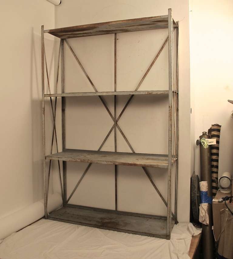 A large and unusually stylish industrial steel shelving unit with original paint and some oxidization.