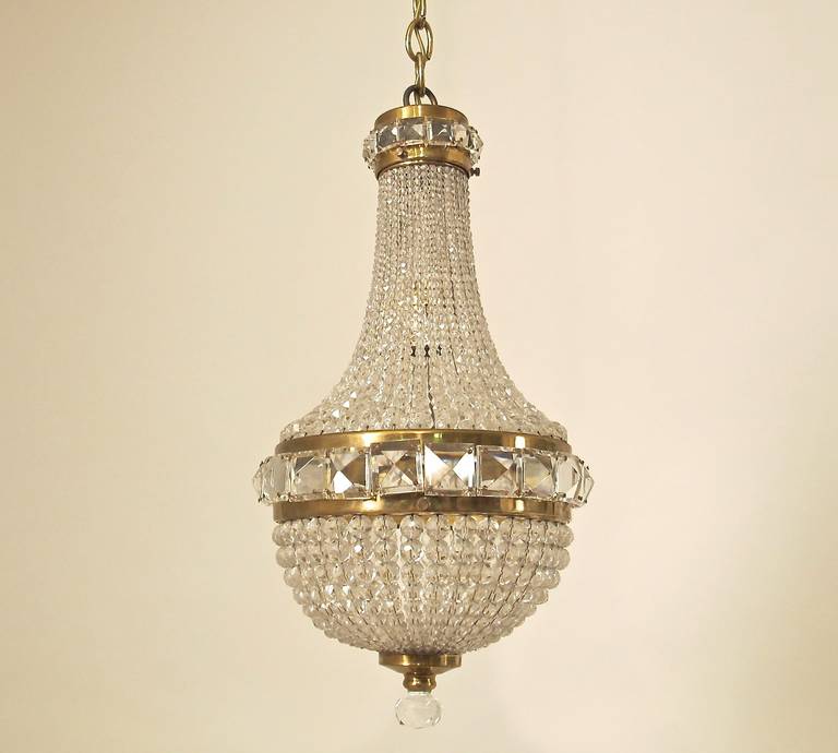 A fine quality cut glass, crystal and brass pendant light fixture. Newly re-wired, holds a single standard size light bulb and comes with 26 inches of chain. Italian, mid-20th century.