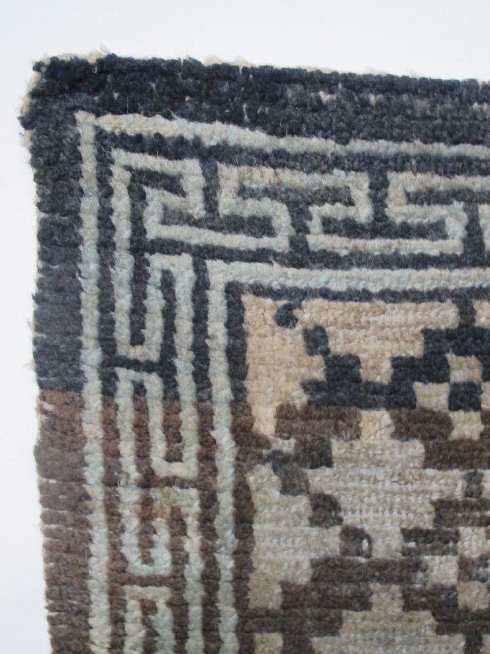 A small indigo and natural color Tibetan wool carpet. Late 19th/early 20th century.