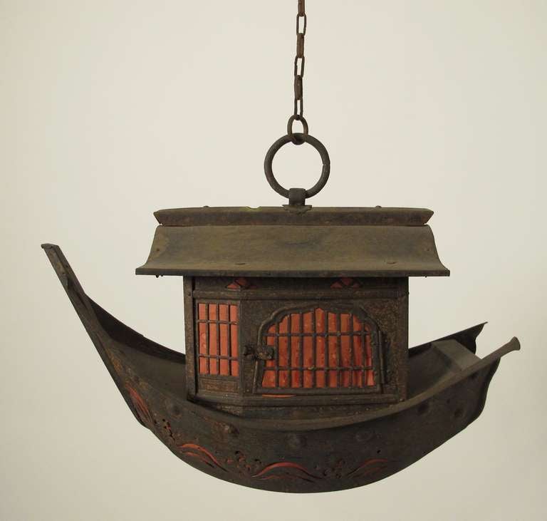 Unusual antique lantern made of patinated metal with red paper inserts around the windows and door.  In original condition as a candle lantern, but can be electrified if desired Japan, circa 1900.