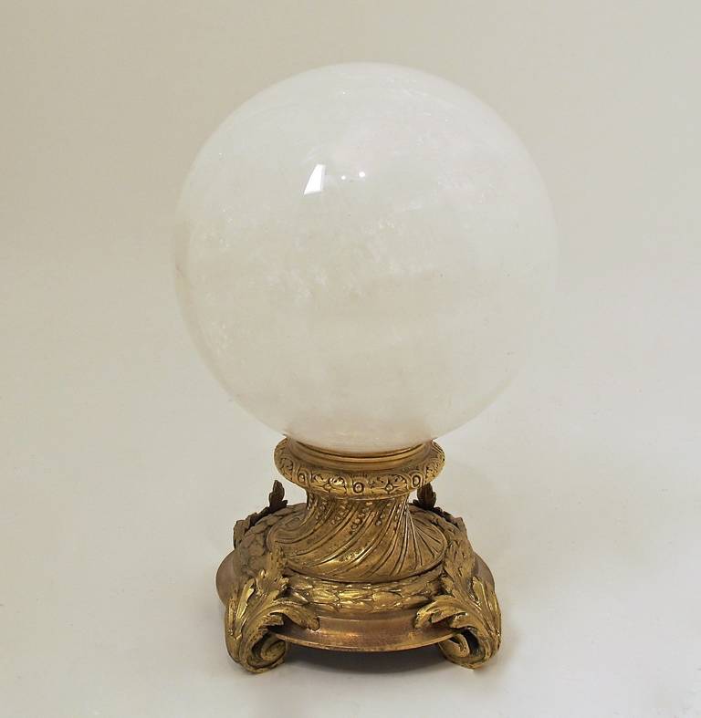 A large rock crystal sphere on ornate antique gilt bronze stand.