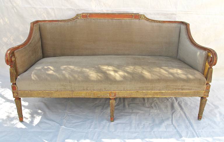 An exceptionally good looking and good quality painted and gilt classic sofa with nicely carved detail, and the legs ending in brass feet. Comfortable and sturdy.