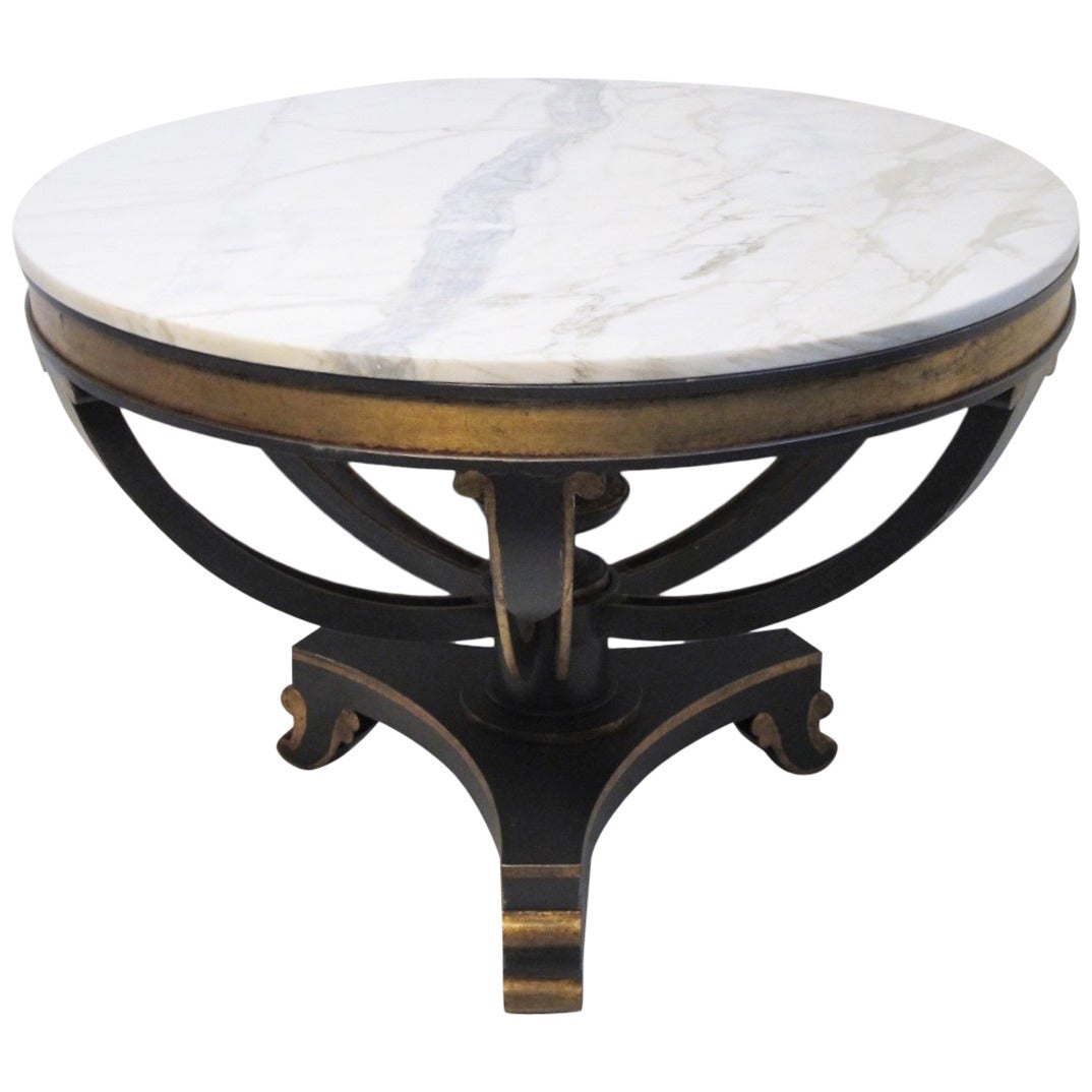 A very attractive round center table. Dark brown painted iron base with gilt accents and marble top. Designer made, high quality.